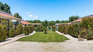 A row of modern, single-story buildings with a gravel driveway leading to a central lawn. - Mobile Home in Banjole near Beach Centinera (Banjole)