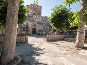 A church with a large arched entrance and a bell tower. - Holiday Home in Fano near the Beach (Fano)