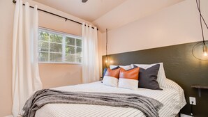 A bedroom with a bed, curtains, a window with blinds, a headboard, and a wall-mounted light fixture. - ⫷1 BD/1 Bath⫷Tiny Magnolia Retreat⫷  ⫸Near TTU⫸ (Lubbock)