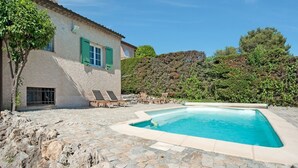 A house with a swimming pool, stone patio, and a hillside backdrop. - Riviera Hideaway for 2 Guests (La Roquette-sur-Siagne)