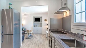 A modern kitchen with stainless steel appliances, a marble countertop, and a built-in oven. - Riviera Hideaway for 2 Guests (La Roquette-sur-Siagne)