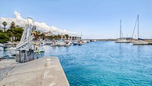 A marina with boats docked, a concrete pier, and buildings in the background. - Villa in Orebić near Sea Beach (Orebić)