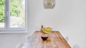 A dining table with a bowl of fruit and a hanging light fixture. - Villa in Orebić near Sea Beach (Orebić)