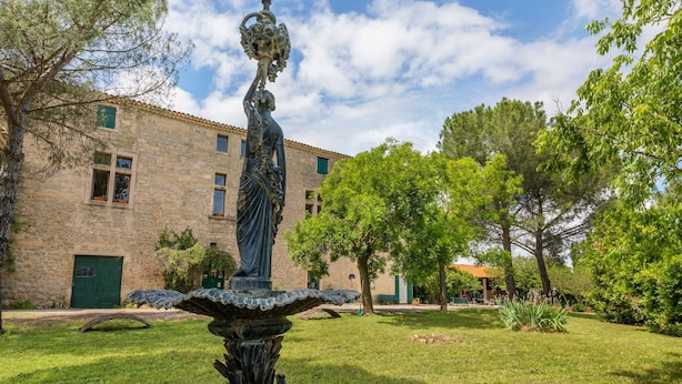 A stone building with a fountain in front. - Flat in a beautiful building with pool (Mèze)