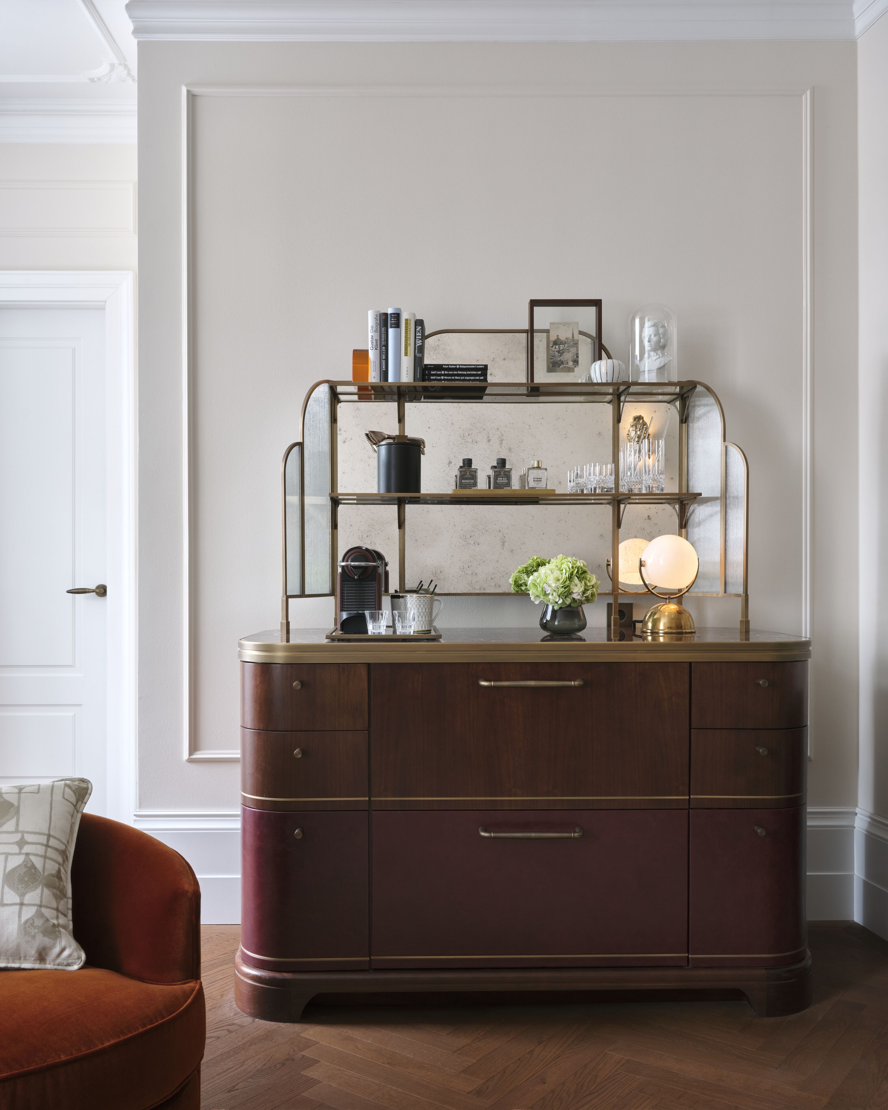 A dark wooden dresser with multiple drawers and a glass top shelf.
