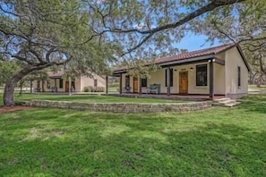 Stylish single-story buildings with flat roofs and a mix of siding and stucco, set amidst manicured lawns and mature trees.