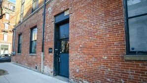A red brick building with a black door and windows.
