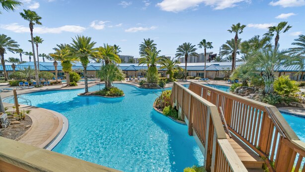 A large outdoor swimming pool with multiple lanes, surrounded by palm trees and lounge chairs. - 2705 Gulf Views ~ Super Deal ~ Heated Pool ~ Resort Bar, Hot Tub ~ Book Sept 7th (Destin)