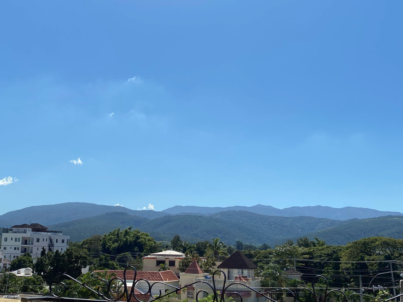 A residential area with houses and mountains in the background.