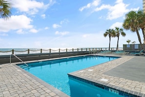 Relax by the pool with a stunning ocean view.