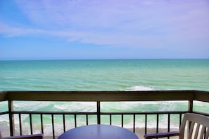 Enjoy a serene view of the sea from this balcony, perfect for dining or relaxation.