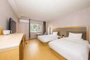 A hotel room with two beds, a desk, a chair, a window, and a television. - Ji Hotel (Beijing)