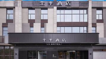A hotel building with a modern facade, large windows, and a prominent entrance.