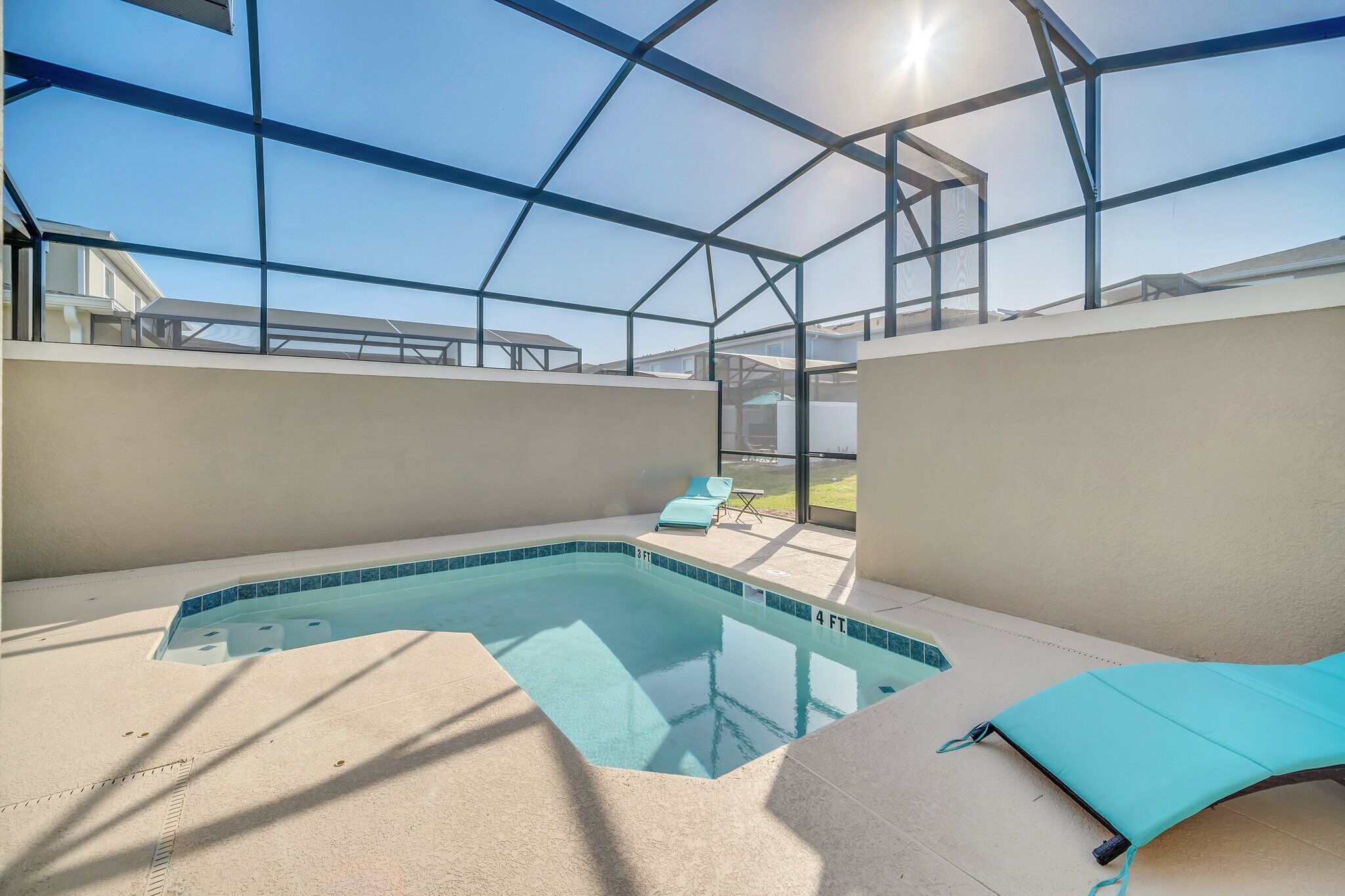 An indoor swimming pool with a glass ceiling, a sunshade, and a lounge chair.