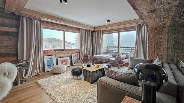 A cozy cabin interior with a wooden ceiling, a bed, a sofa, and a dining area. - Standing megeve - 2 to 8 people - Mont Arbois - ⛷️ and 🏌️‍♀️ (Megeve)