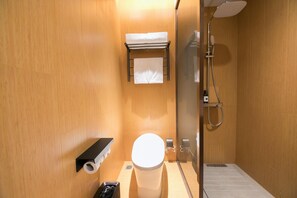 A compact bathroom with a toilet, a towel rack, a shower, and a waste bin. - Ji Hotel Beijing Happy Valley (Beijing)