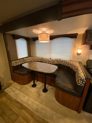 Cozy seating area with a table and cushioned benches, perfect for relaxing.