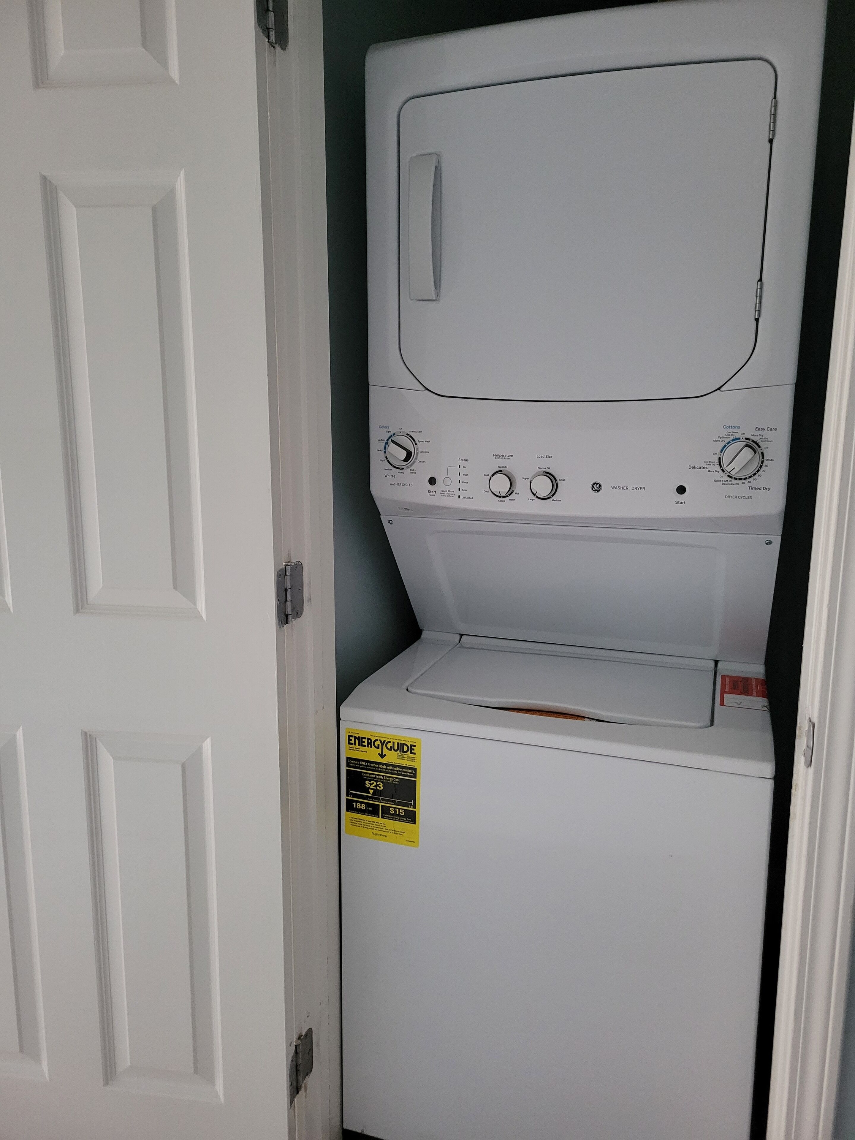 A front-loading washer and dryer unit with a visible ENERGY GUIDE sticker.