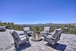 A rooftop patio with four gray cushioned chairs and a metal table, overlooking a mountainous landscape. - Panoramic Mtn Views: Prescott Sunset Sanctuary (Prescott)