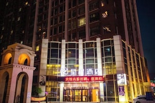 A hotel with a modern facade, large windows, and a prominent entrance.