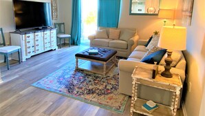 A living room with a television, sofa, coffee table, and a lamp. - Newly remodeled condo minutes to the Strip, Lake & SDC with AMAZING views! (Branson)