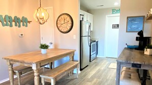 A kitchen with a wooden table, bench, and a clock on the wall. - Newly remodeled condo minutes to the Strip, Lake & SDC with AMAZING views! (Branson)
