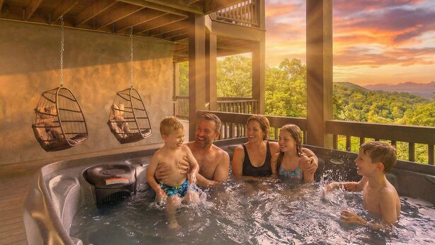 A hot tub area with hanging chairs and a view of the landscape.