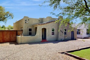 Situated on a quiet driveway, this charming home features a small porch and an entrance.