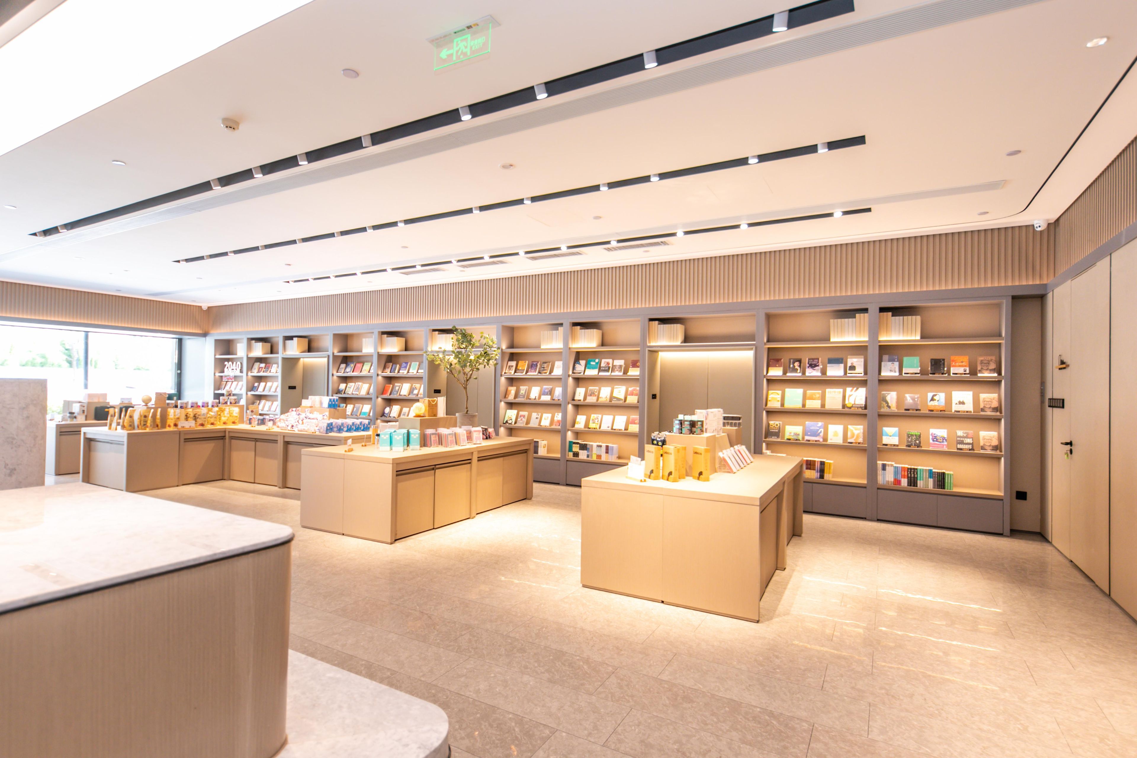 A modern interior with a central counter, multiple shelving units, and a clean, organized layout.