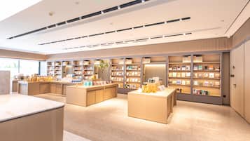 A modern interior with a central counter, multiple shelving units, and a clean, organized layout.
