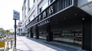A hotel with a modern facade, large glass windows, and a sign indicating it is a hotel.