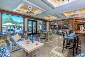 Relax in a spacious, well-lit area with multiple seating options and a bar.