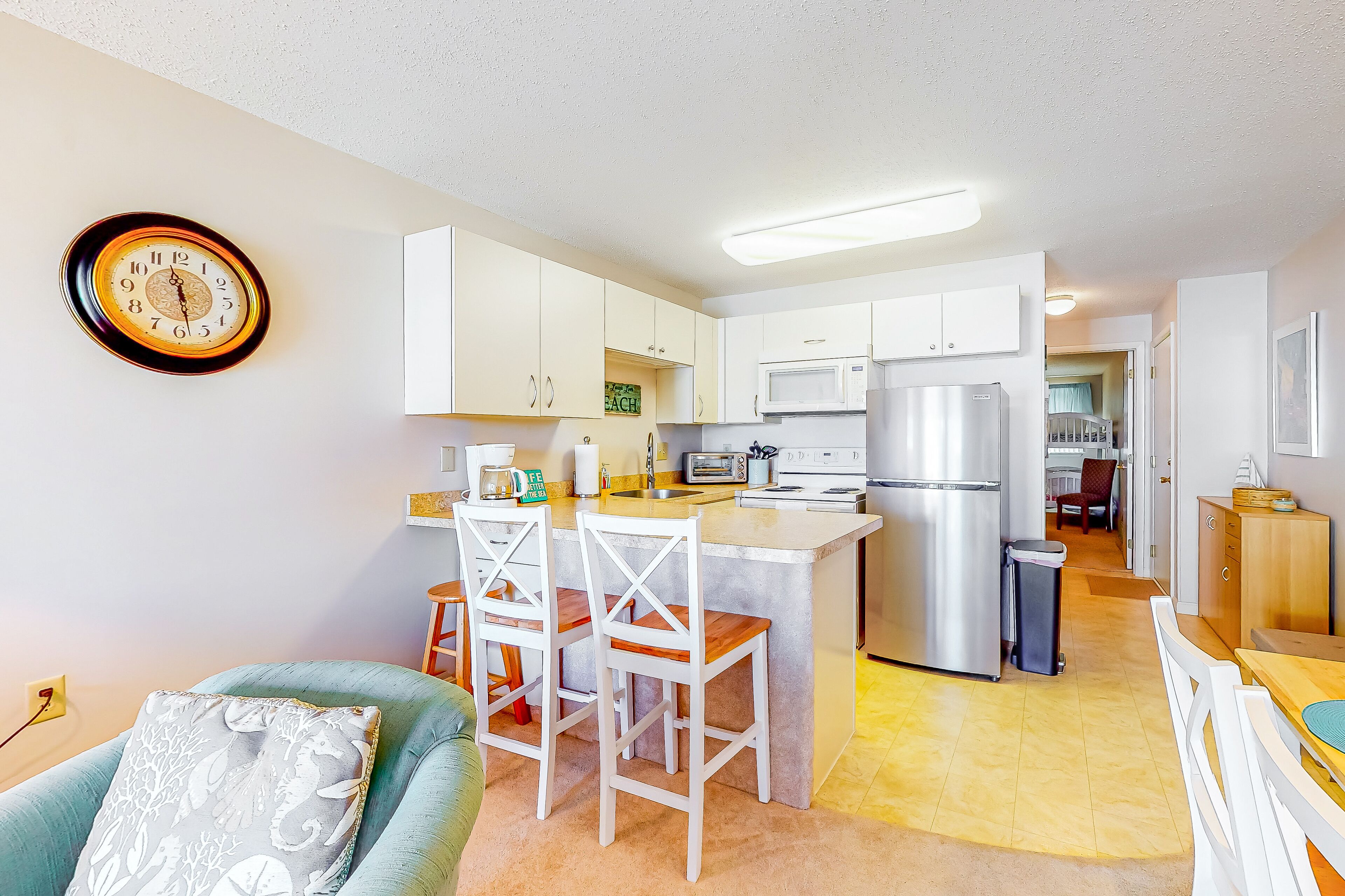 Beachside condo with balcony, ocean views, outdoor shower, and walkable locale