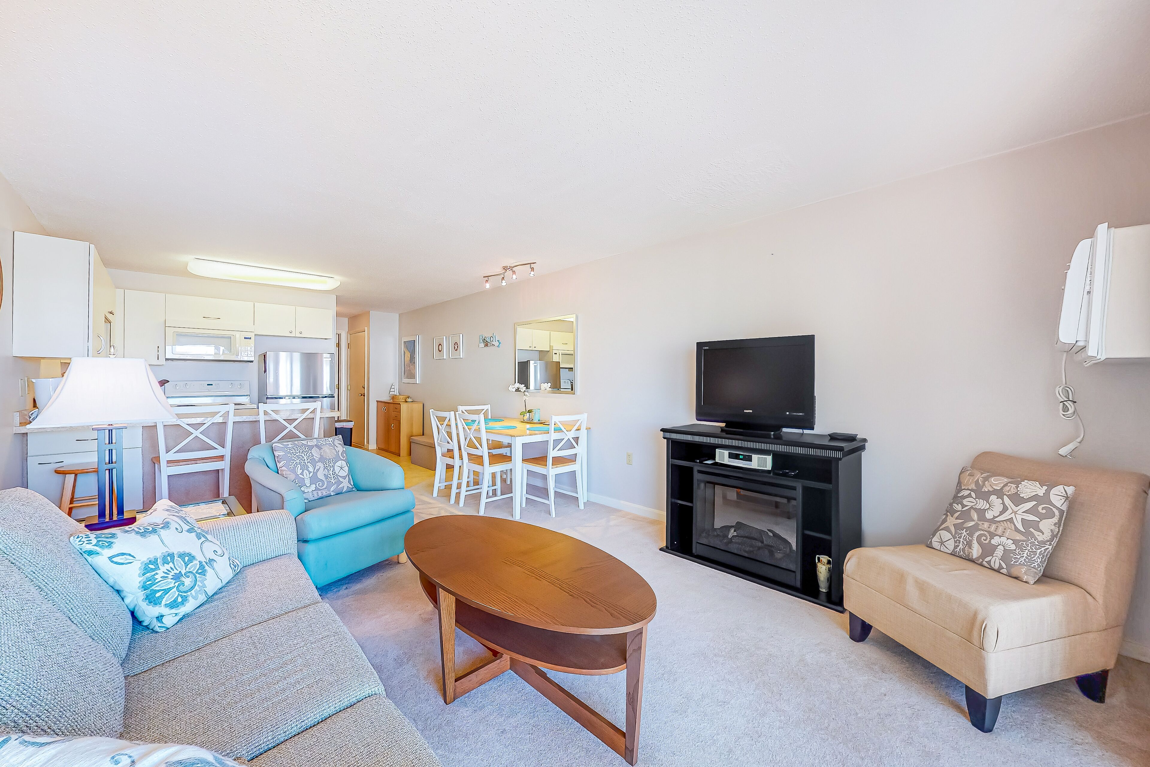 Beachside condo with balcony, ocean views, outdoor shower, and walkable locale