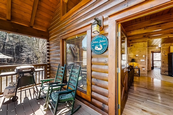 Enjoy a meal on the porch with a grill and seating area, or dine indoors at the wooden table.