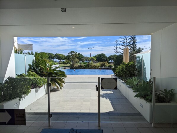 A pool area with a sign indicating pool hours.