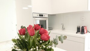 A modern kitchen with white cabinets, a stainless steel oven, and a sink. - Aria 3 - Vacation Apartment in Crete, 100 m from the seaside (Kolimbári)