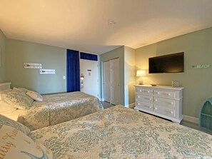 A hotel room with two beds, a dresser, a television, and a sign that says "Beach". - Ocean Dunes by Palmetto Vacations (Myrtle Beach)