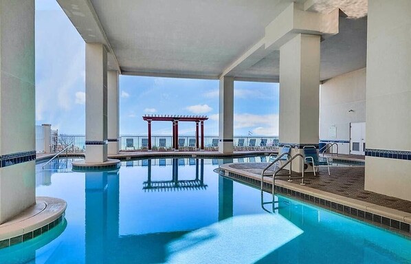 Relax by the pool surrounded by lounge chairs and a covered seating area.