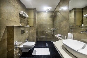 A modern bathroom with a glass-enclosed shower, a white sink, and a large bathtub. - Lords Inn Chandigarh Zirakpur (Dera Bassi)