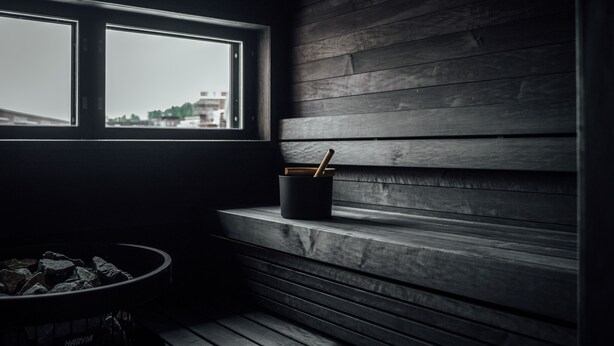 A dimly lit room with a window, a black trash bin, and a Harvia branded ashtray. - Unity Tampere - A Studio Hotel (Tampere)