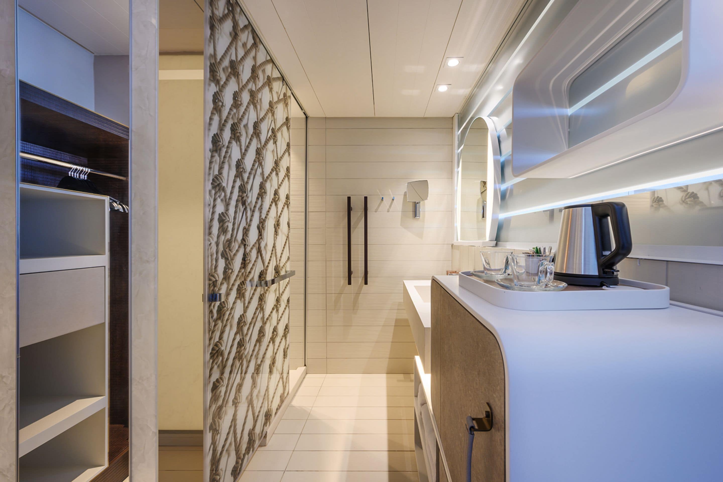 A modern bathroom with a shower, a toilet, and a sink area.