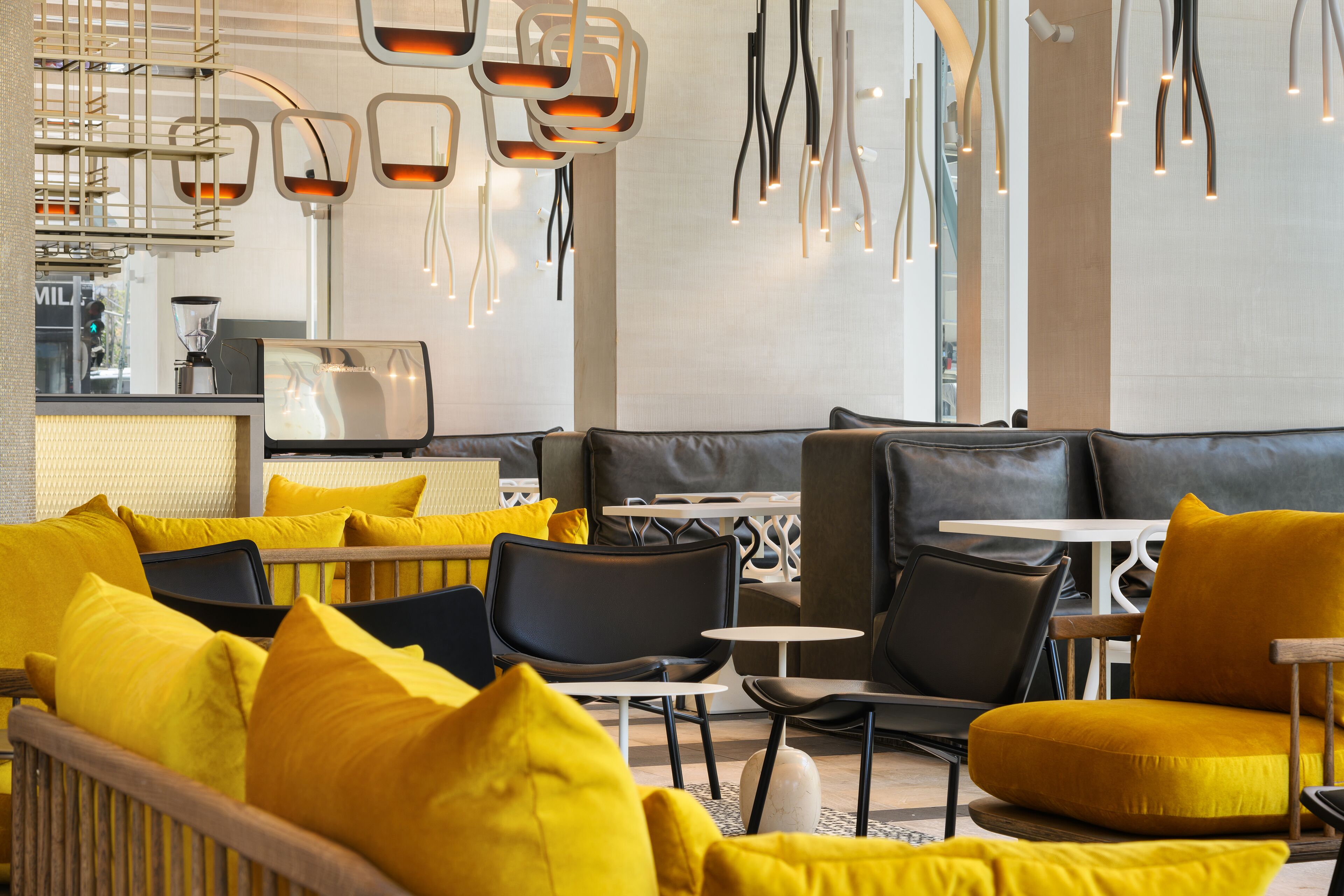 Un ambiente moderno con disposizione dei posti a sedere e lampade dal design contemporaneo.