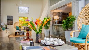 A spacious living area with a coffee table, books, and decorative plants. - The Villa Bentota by KK Collection (Bentota)