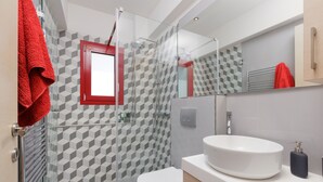A modern bathroom with a glass-enclosed shower, a white sink, and a toilet. -  A Luxury Retreat in Corfu Town by Konnect, Two-Bedroom Apartment (Corfu)
