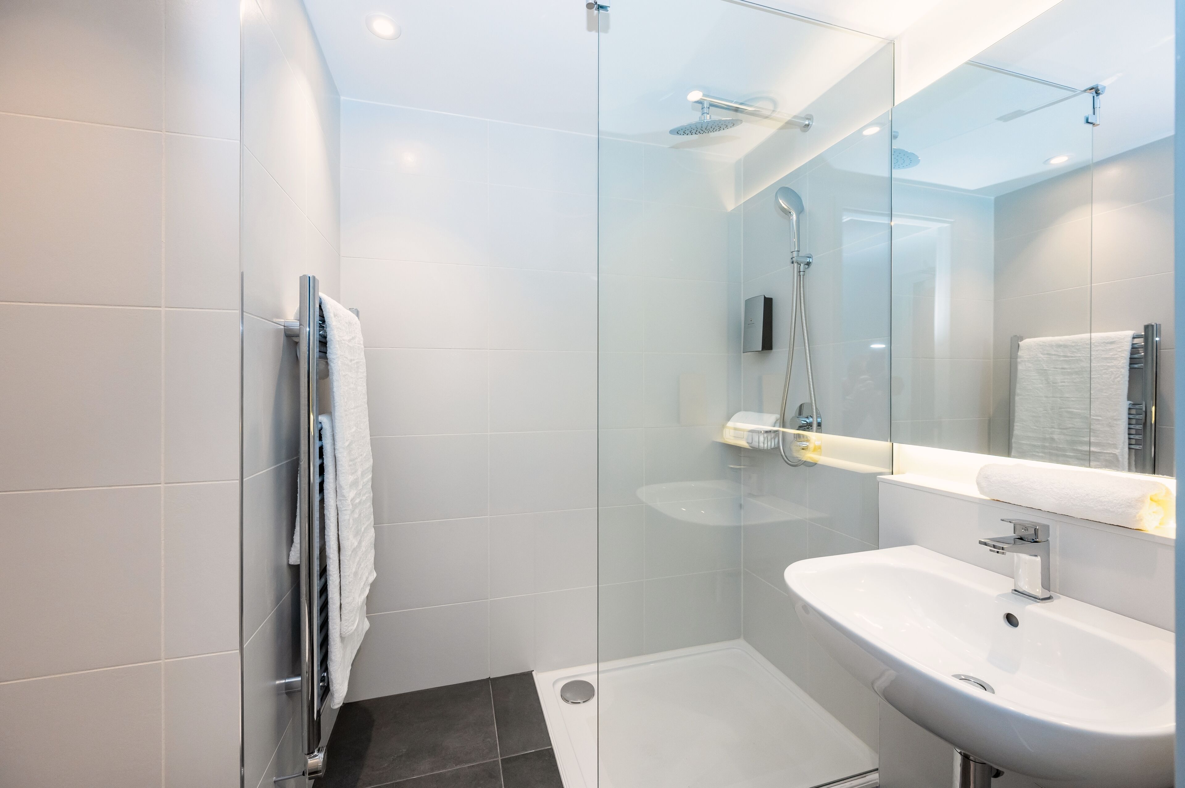 shower, rainfall showerhead, hair dryer, towels