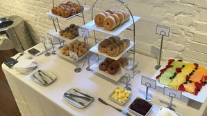 A buffet table with various food items like pastries, mini muffins, and fruit platters. - The Stand Leisure Nairobi West (Nairobi)