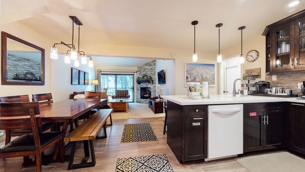 A modern kitchen with a central island, dark cabinetry, and pendant lighting. - St. Anton 54 Steps to Canyon Lodge, Remodeled, Covered Parking by RedAwning (Mammoth Lakes)