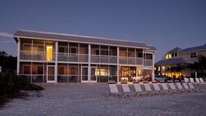 A multi-story hotel with balconies, a beachside location, and outdoor seating. - Resort Sixty-Six (Holmes Beach)