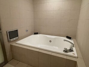 A modern bathroom with a large bathtub, a handheld showerhead, and a digital control panel. - HOTEL Fuuga Luxury Resort - Adults Only (Maizuru)